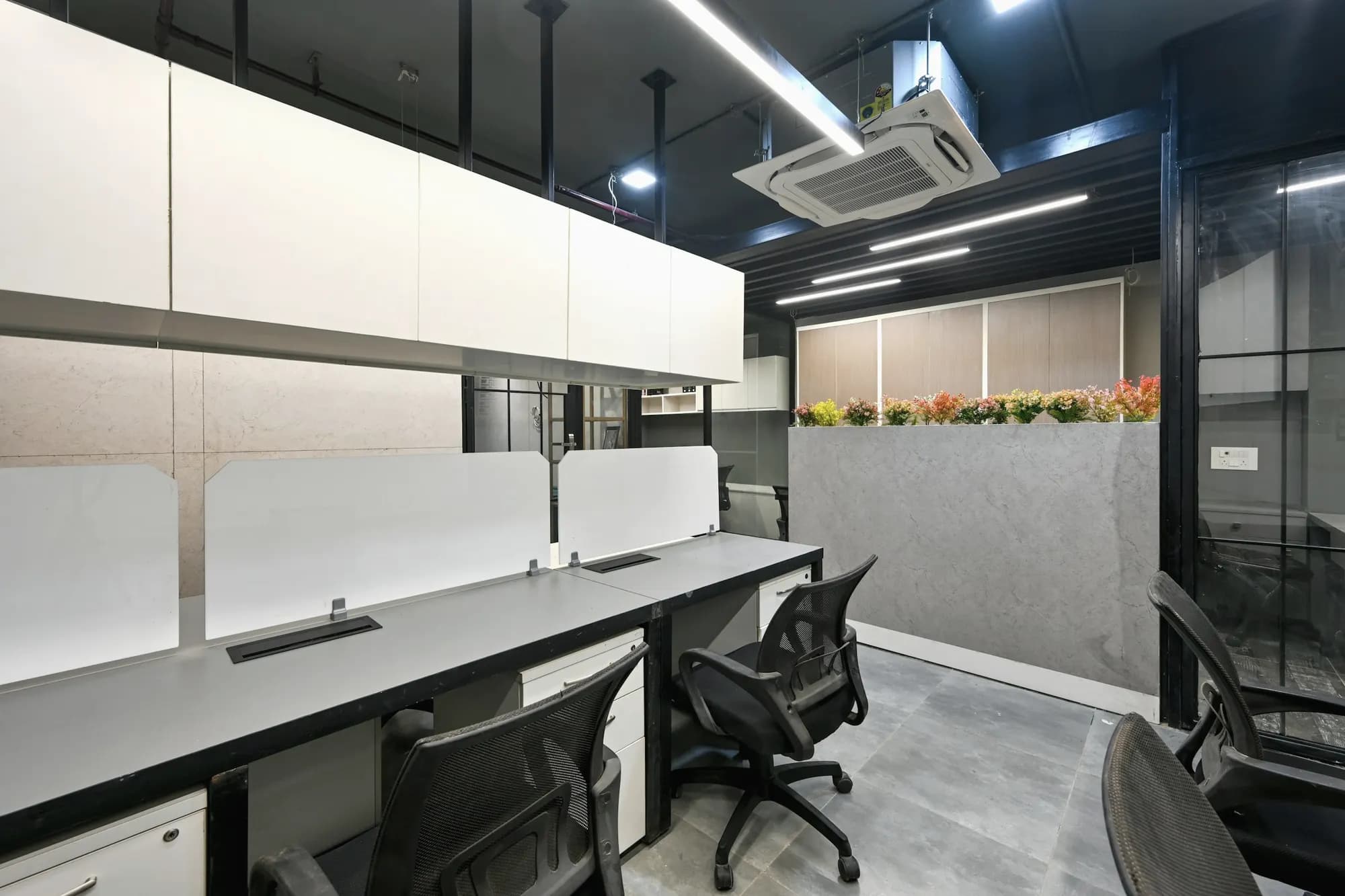 An empty row of workstations in a New Delhi office